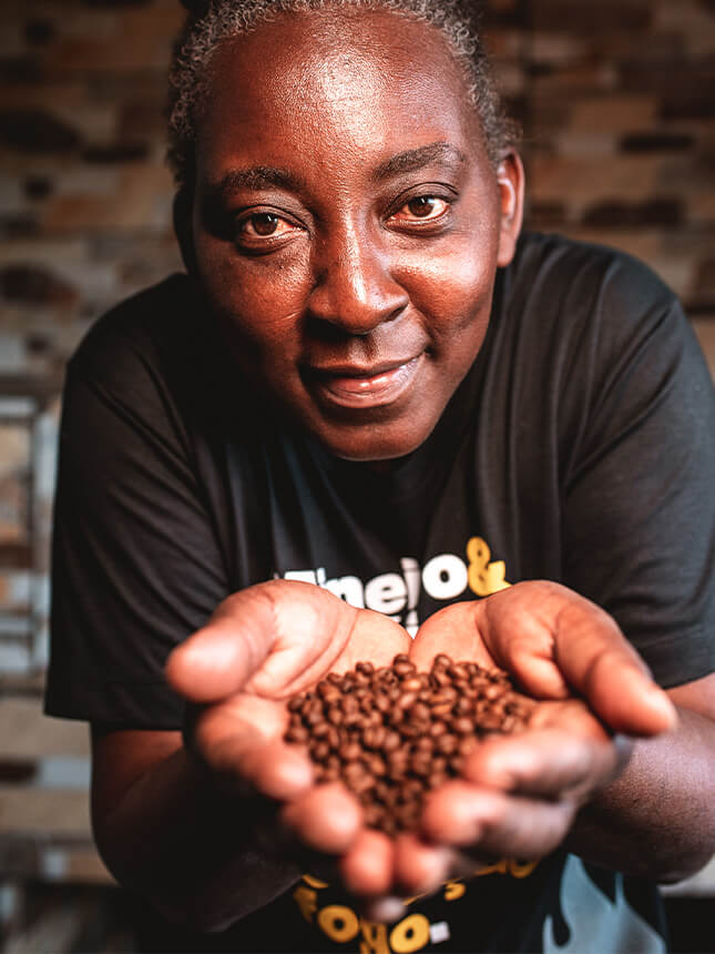 A person with coffee beans in their hands