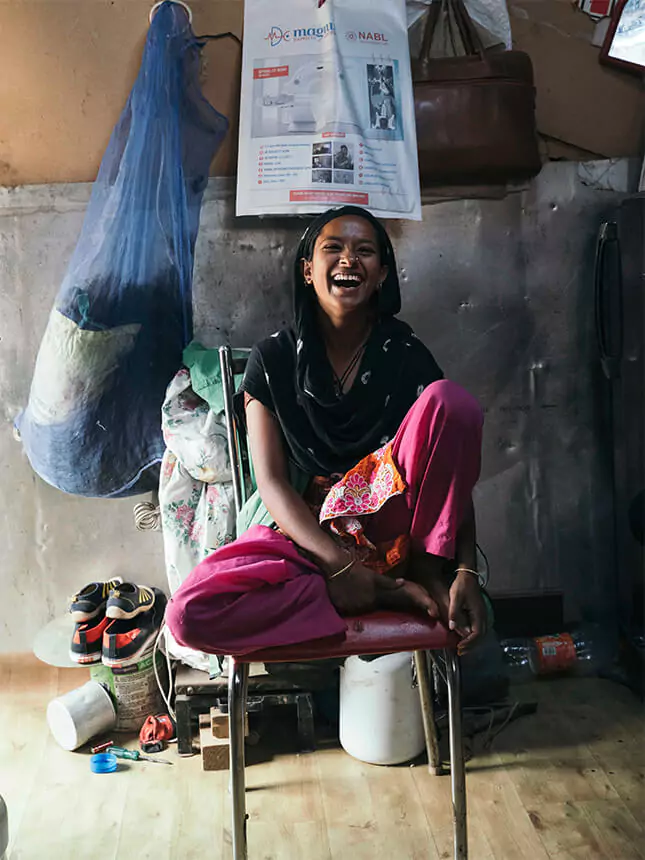 A woman laughing at the camera