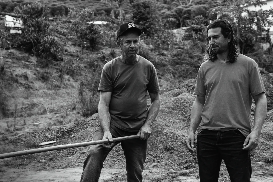 Two men in black and white on a composting site (Photo)