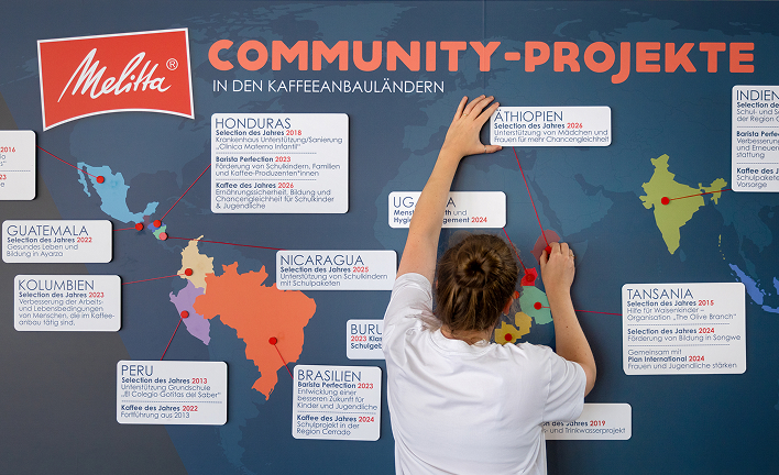 Protagonist attaches a sign labeled Ethiopia to Melitta&rsquo;s world map of community projects in coffee-growing countries.